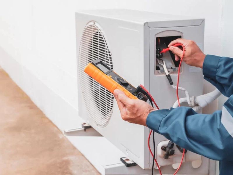 Technician servicing an air conditioner